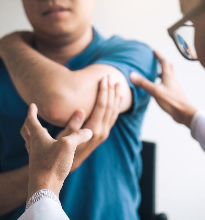 Doctor examining patient’s shoulder