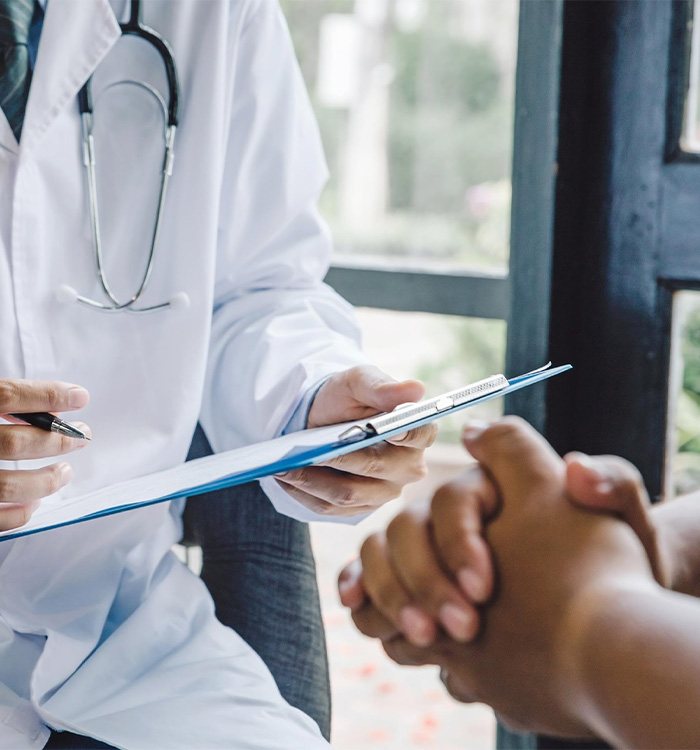 Doctor taking notes during patient consultation