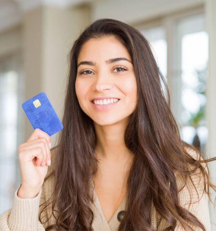 Smiling woman holding her payment card