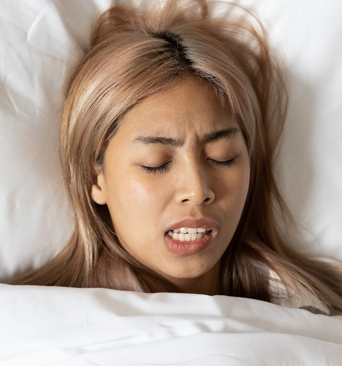 Person grinding their teeth while asleep
