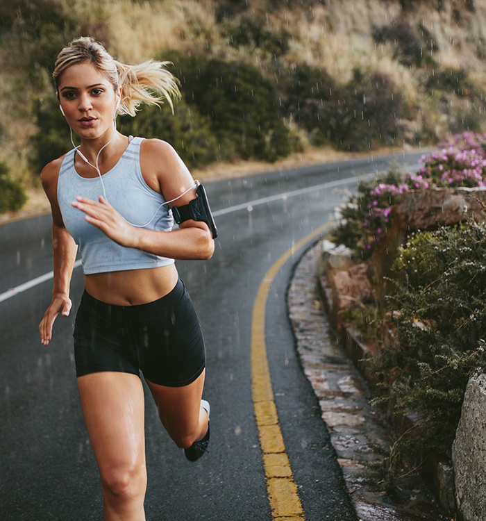 Woman running outdoors during rainy weather