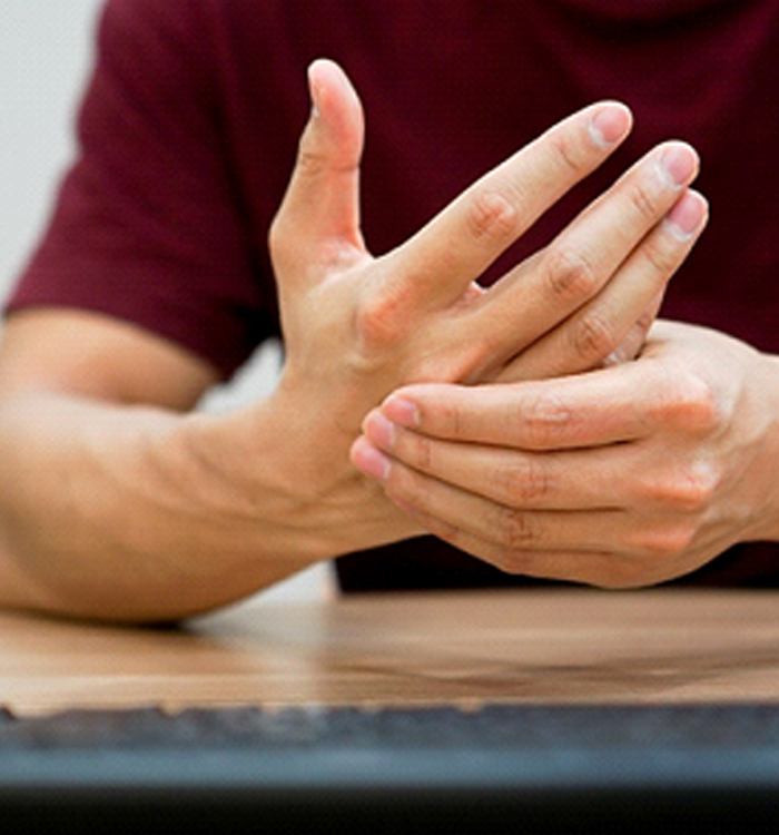 man with Carpal Tunnel Syndrome holding wrist