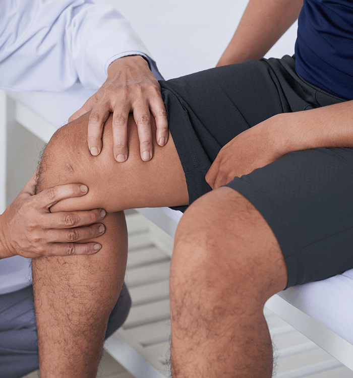 Doctor examining patient’s knee