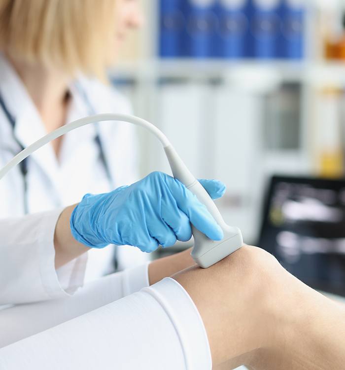 Doctor examining patient’s knee