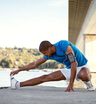 athletic man stretching outdoors