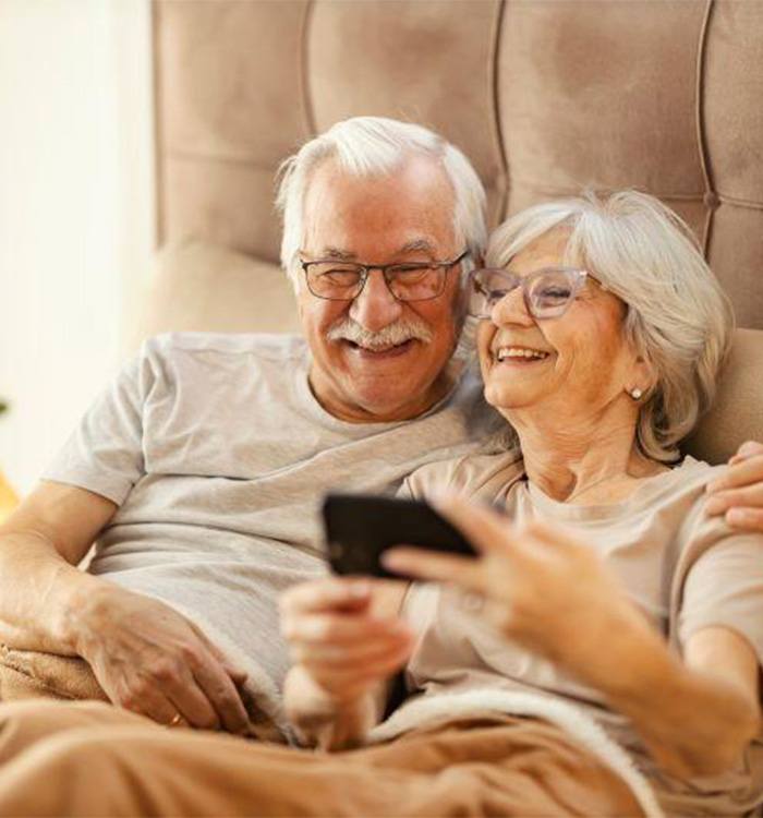 Senior couple relaxing in bed together