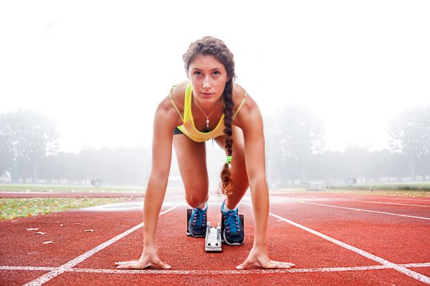 Woman on track, preparing to run