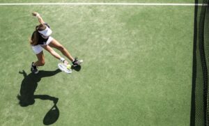 Woman enthusiastically playing tennis